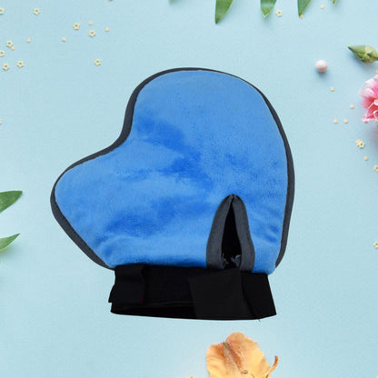 Pet grooming glove deshedding tool mitt for dogs and cats, blue soft mitt against a floral background.